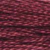 A close-up view of embroidery thread skeins, held taught horizontally. The shade is a deep purplish red, like a nice Merlot.