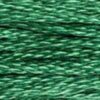 A close-up view of embroidery thread skeins, held taught horizontally. The shade is a beautiful medium light true green, like a field of shamrocks