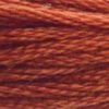 A close-up view of embroidery thread skeins, held taught horizontally. The shade is a pretty medium reddish orange, like citrus chocolate 
