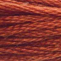 A close-up view of embroidery thread skeins, held taught horizontally. The shade is a pretty medium reddish orange, like citrus chocolate 