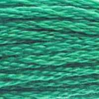 A close-up view of embroidery thread skeins, held taught horizontally. The shade is a medium dark sea green with just a mild touch of blue, like the ocean in a tropic port