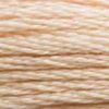 A close-up view of embroidery thread skeins, held taught horizontally. The shade is a light peachy tan, like tropical beach sand