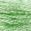 A close-up view of embroidery thread skeins, held taught horizontally. The shade is a pretty light creamy green, like lime Jell-o