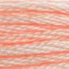 A close-up view of embroidery thread skeins, held taught horizontally. The shade is a light pink that leans towards orange just a bit, like a peach ice cream float