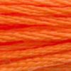 A close-up view of embroidery thread skeins, held taught horizontally. The shade is a pretty medium light true orange, like the orange stripe on a piece of candy corn.