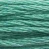 A close-up view of embroidery thread skeins, held taught horizontally. The shade is a medium light bluish green, like a shallow ocean pool