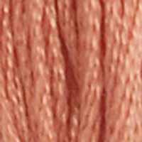 A close-up view of embroidery thread skeins, held taught vertically. The shade is a brownish peach