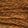 A close-up view of embroidery thread skeins, held taught horizontally. The shade is a lovely medium shade of pure brown, like dark brown sugar