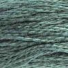 A close-up view of embroidery thread skeins, held taught horizontally. The shade is a medium dark shade about halfway between blue and green, like a blue spruce Christmas tree.