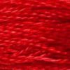 A close-up view of embroidery thread skeins, held taught horizontally. The shade is a medium bright pure red, like a maraschino cherry. 