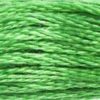 A close-up view of embroidery thread skeins, held taught horizontally. The shade is a bright medium light green, like a shamrock in the sun