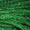 A close-up view of embroidery thread skeins, held taught horizontally. The shade is a beautiful medium dark jewel green, like the spring tips of cedar boughs