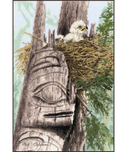 An eagle chick sits in a messy nest in a cleft at the top of a faded totem pole