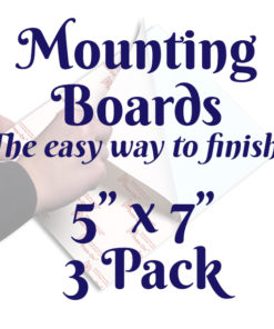 A white square with a faint image of a person's hands using a mounting board. Text in front of it reads, "Mounting Boards, The easy way to finish! 5 inches by 7 inches 3-pack"