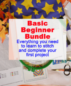 An orange tabletop, with a strand of fall leaves at one corner. Centered is a complete embroidery kit, with pattern, hoop, fabric, scissors, etc. A piece of blue fabric with yellow stars borders the top. Text reads: "Basic Beginner Bundle, Everything you need to learn to stitch and complete your first project"
